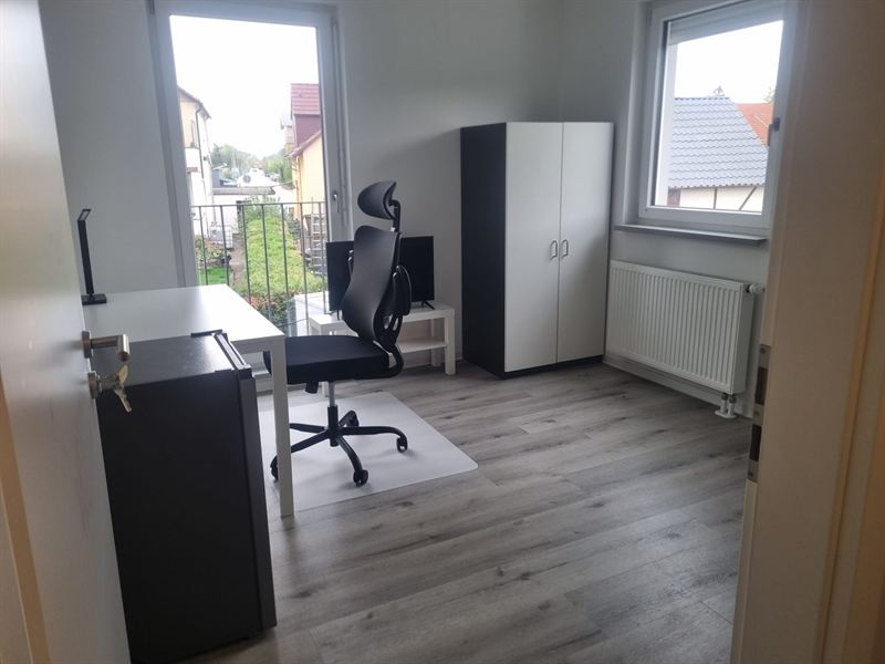 Helles Zimmer mit französischem Balkon, Schreibtisch, Bürostuhl, Kleiderschrank und Fernseher